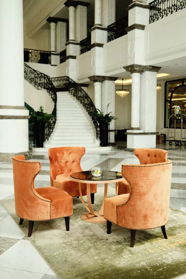 Victoria Moretti Escort - Blick in eine Lounge mit 4 orangen Stühlen